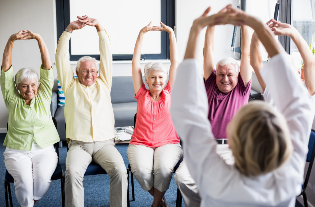 Seniors engaging in stretching at senior community